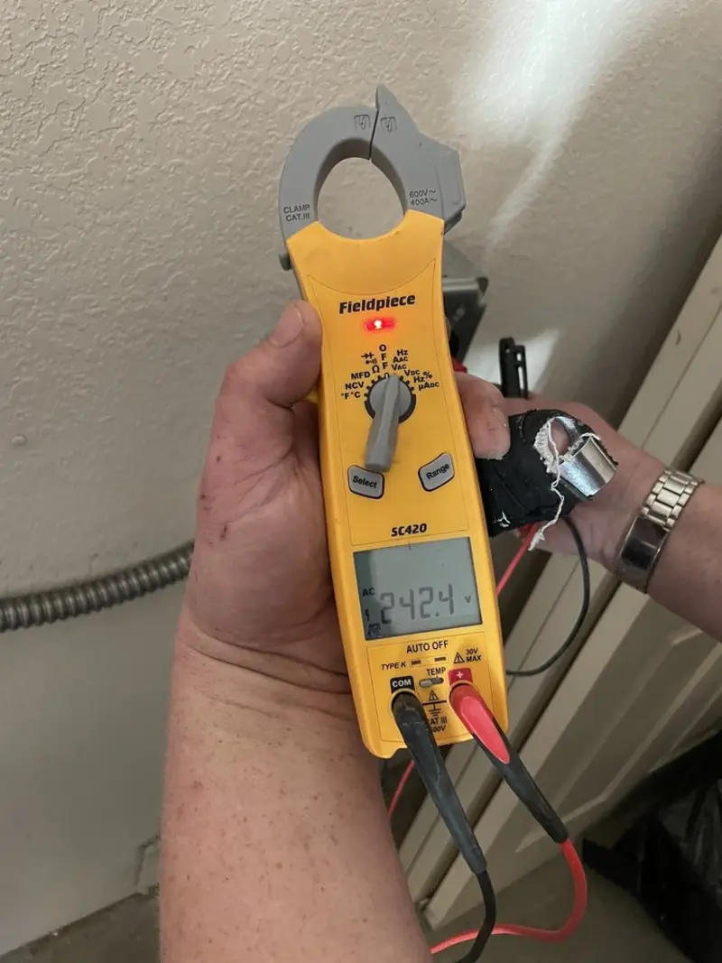 Voltage testing with clamp meter during Recessed Lighting Installation in McGehee